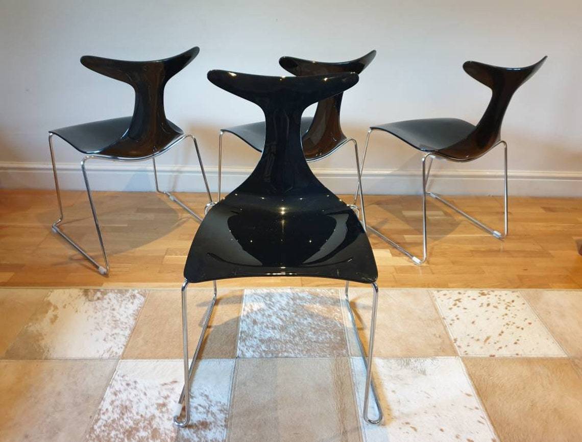 A Set Of Four Designer Stacking "Delfy" Chairs Designed By Gino Carollo